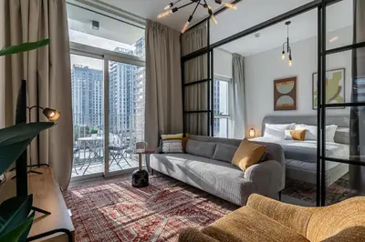 a living room with a couch and a bed at Upgraded Interior I Dubai Hills I City View I Socio Tower in Dubai