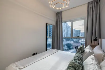 a bedroom with a bed and a large window at Upgraded Interior I Dubai Hills I City View I Socio Tower in Dubai
