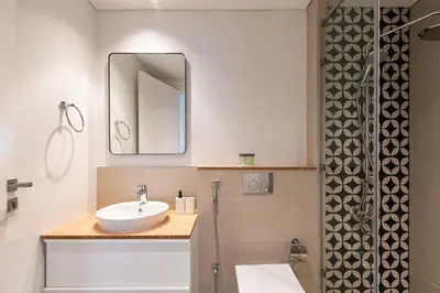 a bathroom with a sink and a mirror and a shower at Upgraded Interior I Dubai Hills I City View I Socio Tower in Dubai