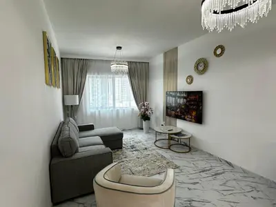 a living room with a couch and a chair at Stay in heart of Dubai Marina, walk to JBR! #3 in Dubai