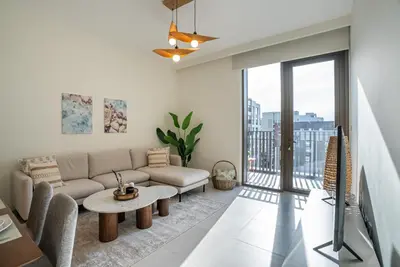 a living room with a couch and a table at Coastal Vibe I 1BDR apartment in Creek Beach I Summer 2 in Dubai