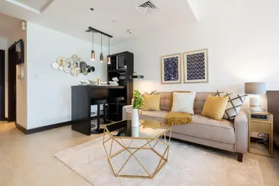 a living room with a couch and a table at GuestReady Holiday Homes - Lux Studio with a View in Dubai