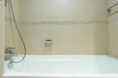 a bathroom with a bath tub and a shower at GuestReady Holiday Homes - Lux Studio with a View in Dubai
