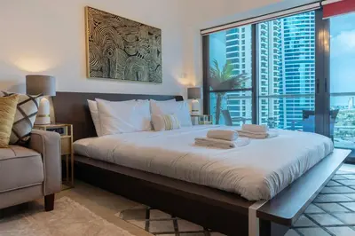 a bedroom with a large bed with a large window at GuestReady Holiday Homes - Lux Studio with a View in Dubai