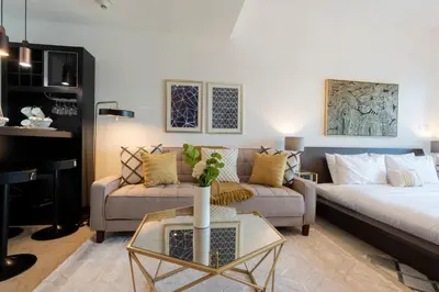 a living room with a couch and a table at GuestReady Holiday Homes - Lux Studio with a View in Dubai