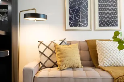 a living room with a couch and a lamp at GuestReady Holiday Homes - Lux Studio with a View in Dubai