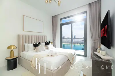 a bedroom with a bed and a large window at LUX The Marina Vista Beachfront Suite in Dubai