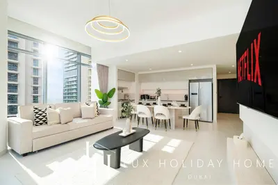 a living room with a couch and a table at LUX The Marina Vista Beachfront Suite in Dubai