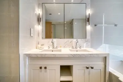 a bathroom with a white sink and a mirror at Downtown Luxury - Stunning Burj Khalifa & Sea View - 5 Minutes Walk to Dubai Mall in Dubai