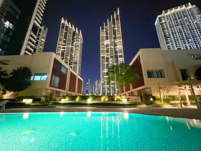 a pool in the middle of a city at night at Downtown Luxury - Stunning Burj Khalifa & Sea View - 5 Minutes Walk to Dubai Mall in Dubai