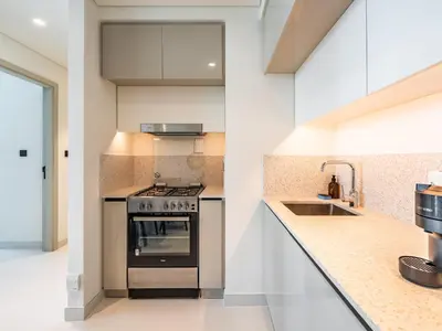 a kitchen with a stove and a sink at Sea-Front Unique Retreat With Balcony in Marina in Dubai