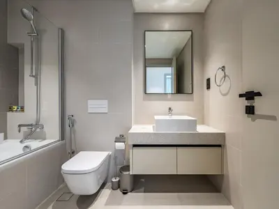 a bathroom with a sink and a toilet and a mirror at Sea-Front Unique Retreat With Balcony in Marina in Dubai