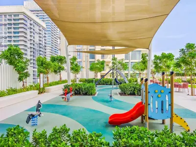 a playground in a building with slides and swings at Sea-Front Unique Retreat With Balcony in Marina in Dubai