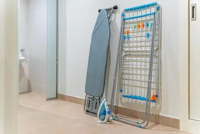 a towel rack in a shower in a bathroom at SettlerHomes - Sparkle Tower 2 With Marina & Sea View in Dubai