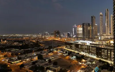 a city lit up at night with tall buildings at 2BR Apt next to DubaiMall, pool view of Burj Khalifa - Downtown Views ll in Dubai