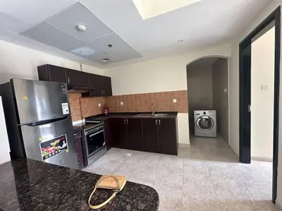 a kitchen with a stainless steel refrigerator and a washing machine at Diomond view 4 in Dubai