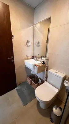 a bathroom with a toilet and a sink at Stylish & Roomy 1BR in the Heart of the City in Dubai
