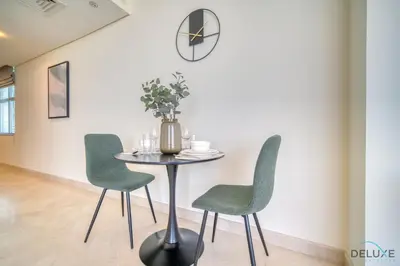 a dining room with a table and two chairs at Grand Studio at Sky Gardens DIFC by Deluxe Holiday Homes in Dubai