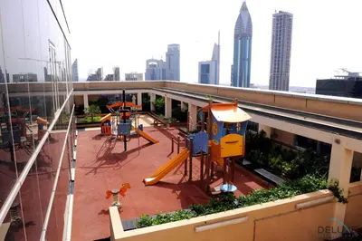 a playground on the roof of a building in a city at Grand Studio at Sky Gardens DIFC by Deluxe Holiday Homes in Dubai