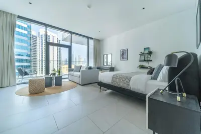 a bedroom with a bed and a large window at Frank Porter - Marquise Square Tower in Dubai