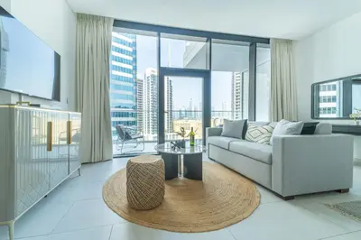 a living room with a couch and a table at Frank Porter - Marquise Square Tower in Dubai