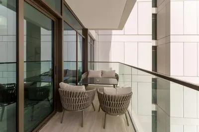 a balcony with a table and chairs in a building at Luxe 1-Bedroom Elegance in Palace Residences in Dubai
