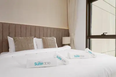 two beds in a hotel room with white sheets at Luxe 1-Bedroom Elegance in Palace Residences in Dubai