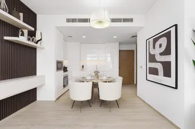 a dining room with a table and two white chairs at Luxe 1-Bedroom Elegance in Palace Residences in Dubai