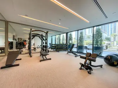 a gym with treadmills and exercise equipment in a building at Luxe 1-Bedroom Elegance in Palace Residences in Dubai