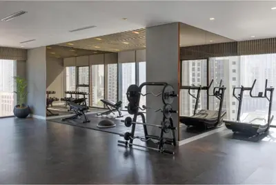 a gym with cardio equipment in a large room at White Sage - Deluxe Apartment With Unobstructed Sea Views in Dubai