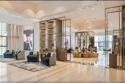 a lobby with couches and chairs in a building at White Sage - Deluxe Apartment With Unobstructed Sea Views in Dubai