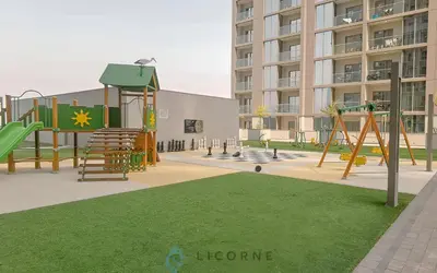 a playground in front of a large building at Inviting 2BR Apartment - Only 10 Mins to Downtown - Sobha Creek Vista Reserve in Dubai