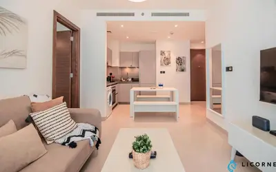 a living room with a couch and a table at Inviting 2BR Apartment - Only 10 Mins to Downtown - Sobha Creek Vista Reserve in Dubai