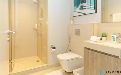 a bathroom with a shower and a toilet and a sink at Brand New Modern 2BR Retreat, Walk to Dubai Mall - Downtown Views ll in Dubai