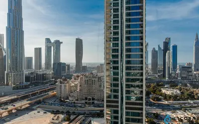 a view of a city with a tall building at Brand New Modern 2BR Retreat, Walk to Dubai Mall - Downtown Views ll in Dubai