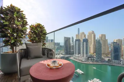 a balcony with a table and a view of the city at 1BR Gem with Stunning Marina Views, Close to Metro in Dubai