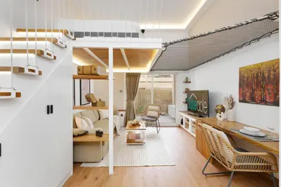 a living room with a loft bed and a desk at Extraordinary Loft Living in JVC by Suiteable in Dubai