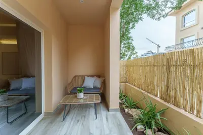 a balcony with a bench and a fence at Extraordinary Loft Living in JVC by Suiteable in Dubai