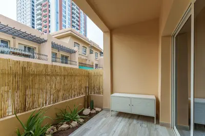 an empty balcony in a building with tall buildings at Extraordinary Loft Living in JVC by Suiteable in Dubai