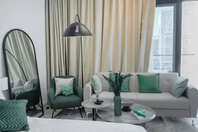 a living room with a couch and two chairs at Clever Guest 014 Binghatti Canal in Dubai