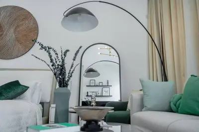 a living room with a couch and a mirror at Clever Guest 014 Binghatti Canal in Dubai