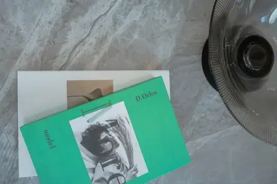 a book sitting on a table next to a camera at Clever Guest 014 Binghatti Canal in Dubai
