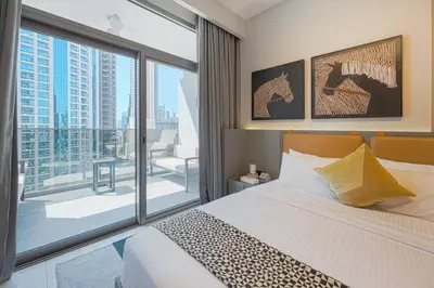 a bedroom with a bed and a large window at Ravishing Studio at MAG 318, Business Bay in Dubai