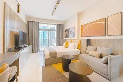 a hotel room with a bed and a couch at Ravishing Studio at MAG 318, Business Bay in Dubai