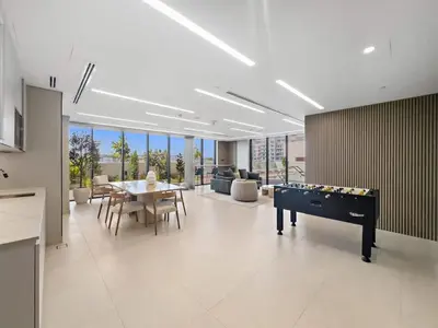 a living room with a ping pong table and a dining room at Luxurious Studio in Westwood by Imtiaz - Al Furjan in Dubai