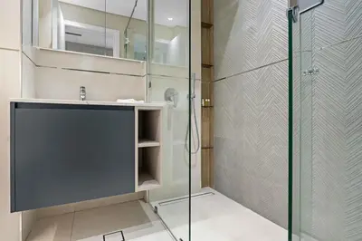 a bathroom with a glass shower and a sink at Luxurious Studio in Westwood by Imtiaz - Al Furjan in Dubai