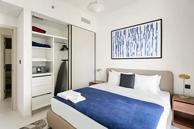 a bedroom with a large bed and a closet at Silkhaus Sea View 1BDR Luxurious New Tower in Dubai