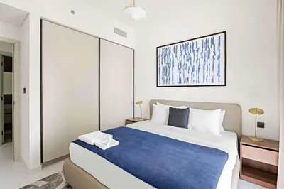a bedroom with a large bed with a blue blanket at Silkhaus Sea View 1BDR Luxurious New Tower in Dubai