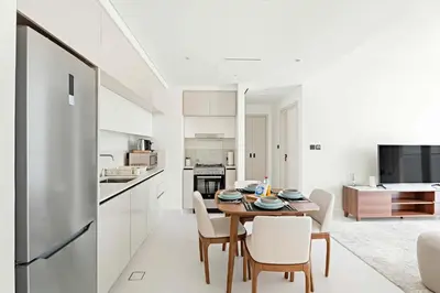 a kitchen and dining room with a table and chairs at Silkhaus Sea View 1BDR Luxurious New Tower in Dubai