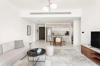 a living room with a couch and a table at Silkhaus Sea View 1BDR Luxurious New Tower in Dubai
